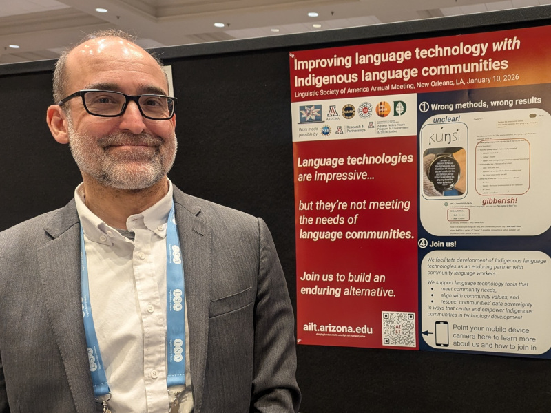 the author standing in front of a recent poster presentation on developing language technology with Indigenous language communities